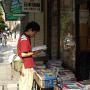 A man reads a map outside a bookstore. Photo by JL, (c) ASC
