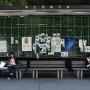 Students relax below a bulletin board Tokyo. Photo by JL, (c) ASC