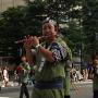 A man plays a wooden flute in the Aomori Nebuta Festival parade. Photo by JL, (c) ASC
