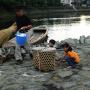 Children examining a hunter's catch along a riverbank in Uji Kyoto. Photo by JL, (c) ASC