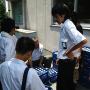 Junior high school students collect bottles of milk to be served with school lunch. Photo by JL, (c) ASC